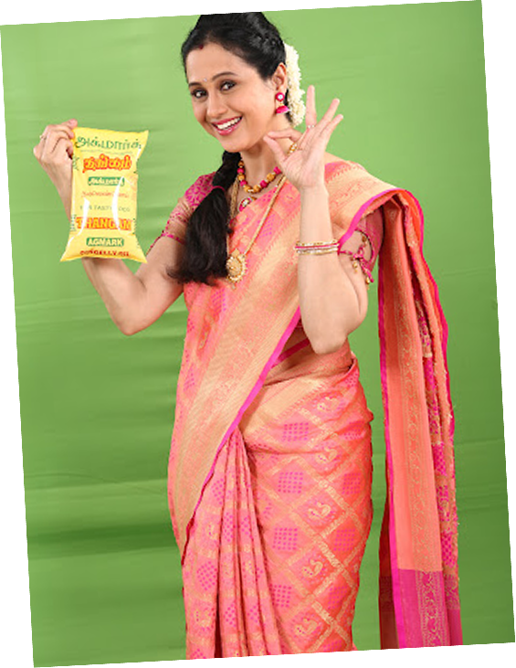 Woman in traditional saree holding THANGAM oil